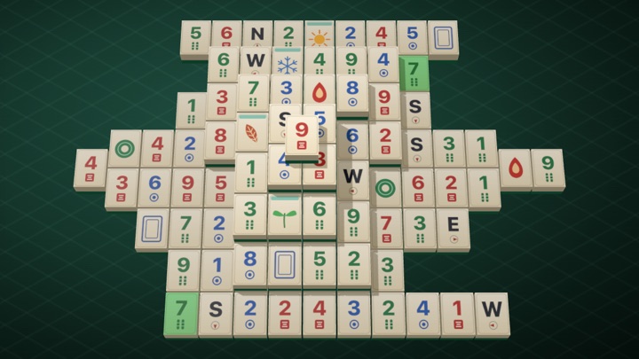 A Mahjong Solitaire turtle layout mid-game: ivory tiles stacked five layers high on a dark green table, two matching tiles lit up